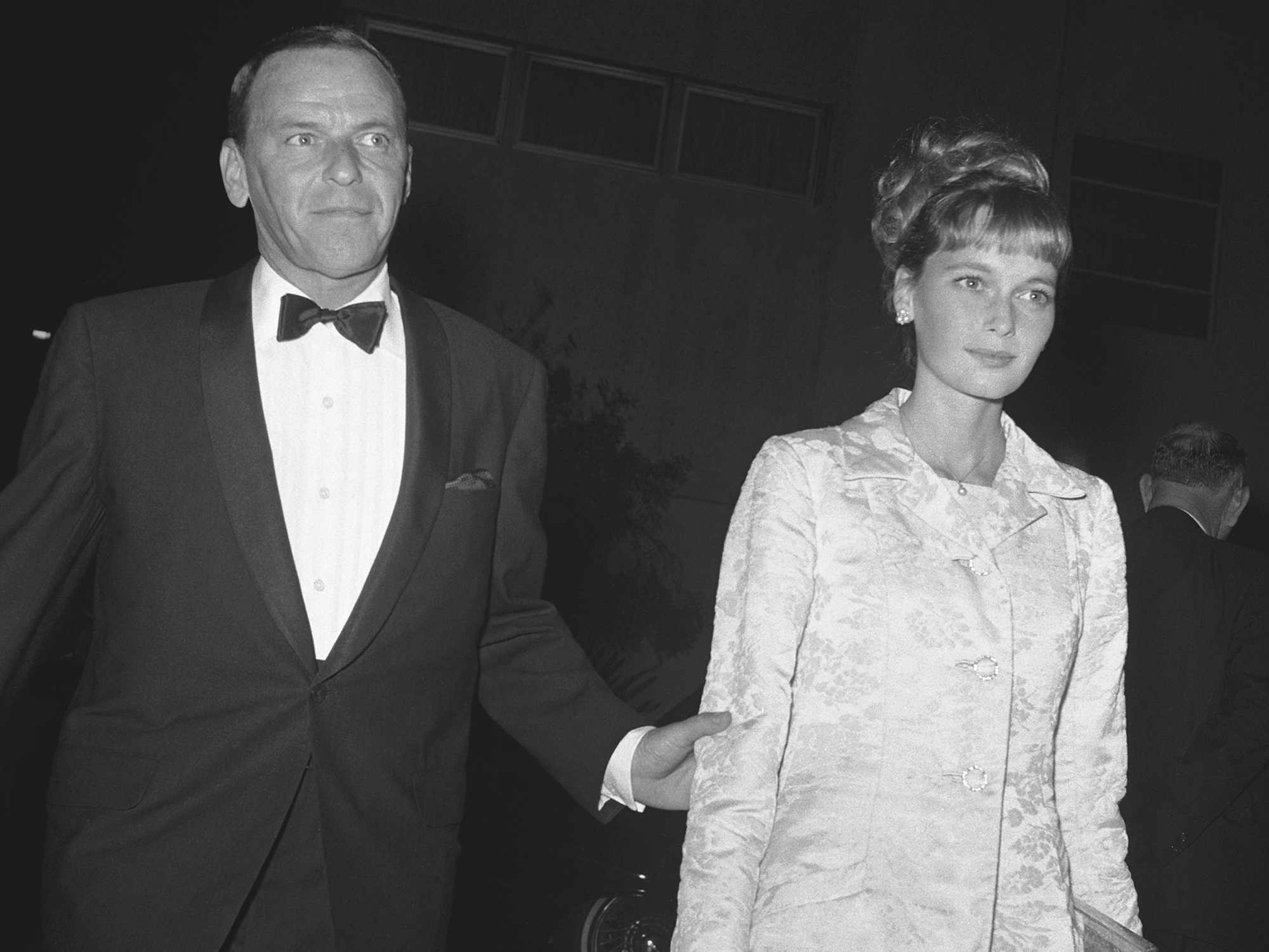 Frank Sinatra and Mia Farrow arrive at the Bistro Restaurant for a black-tie party. 