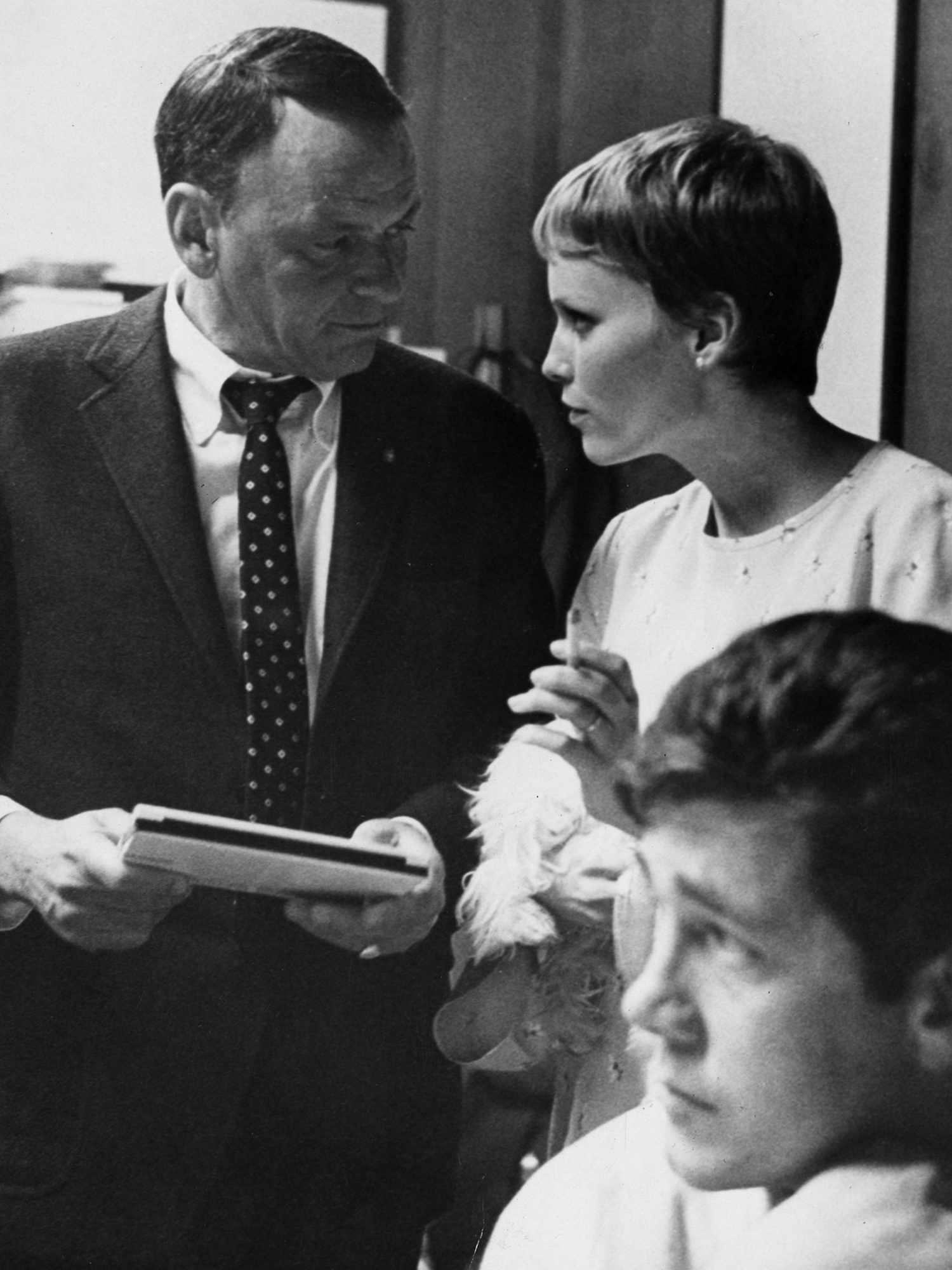 Frank Sinatra and Mia Farrow during a break in a recording session at Hollywood's Sunset Boulevard recording studio.