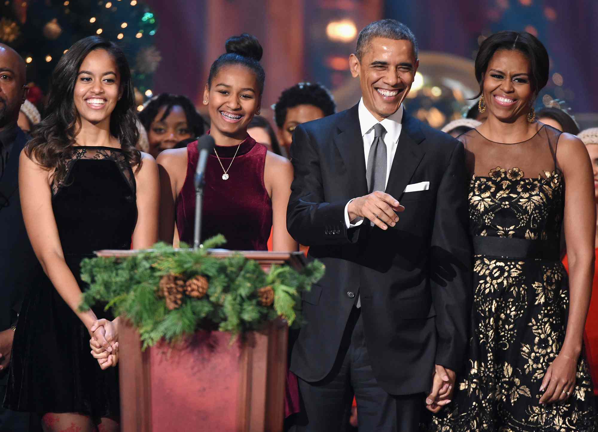 Malia Obama, Sasha Obama, U.S. President Barack Obama, and First Lady Michelle Obama speak onstage at TNT Christmas in Washington 2014 at the National Building Museum on December 14, 2014 in Washington, DC