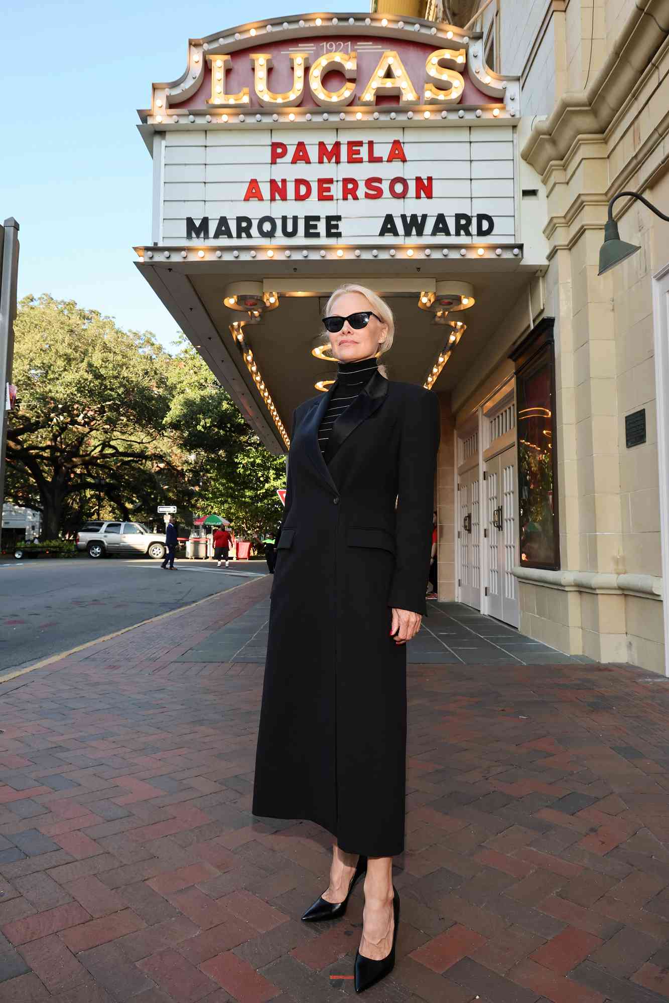 Pamela Anderson poses in front of the marquee ahead of a screening of The Last Showgirl and the Marquee Award presentation duringthe 27th SCAD Savannah Film Festival on November 02, 2024 in Savannah, Georgia. 