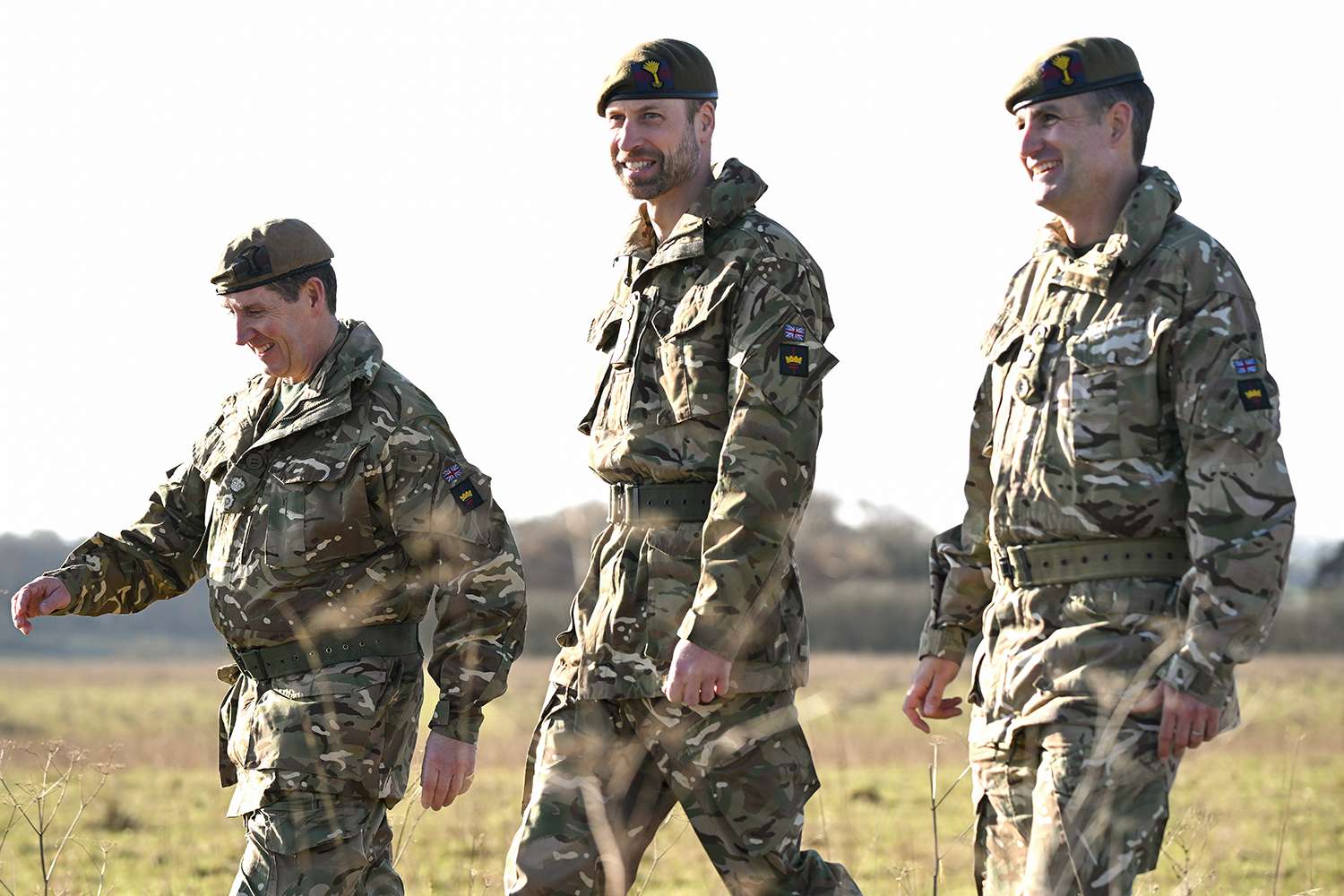 Prince William, Prince of Wales and Colonel of the Welsh Guards (C) shares a joke with military personnel as he arrives for a visit to the 1st Battalion Welsh Guards at Salisbury Plain on November 26, 2024 in Wiltshire