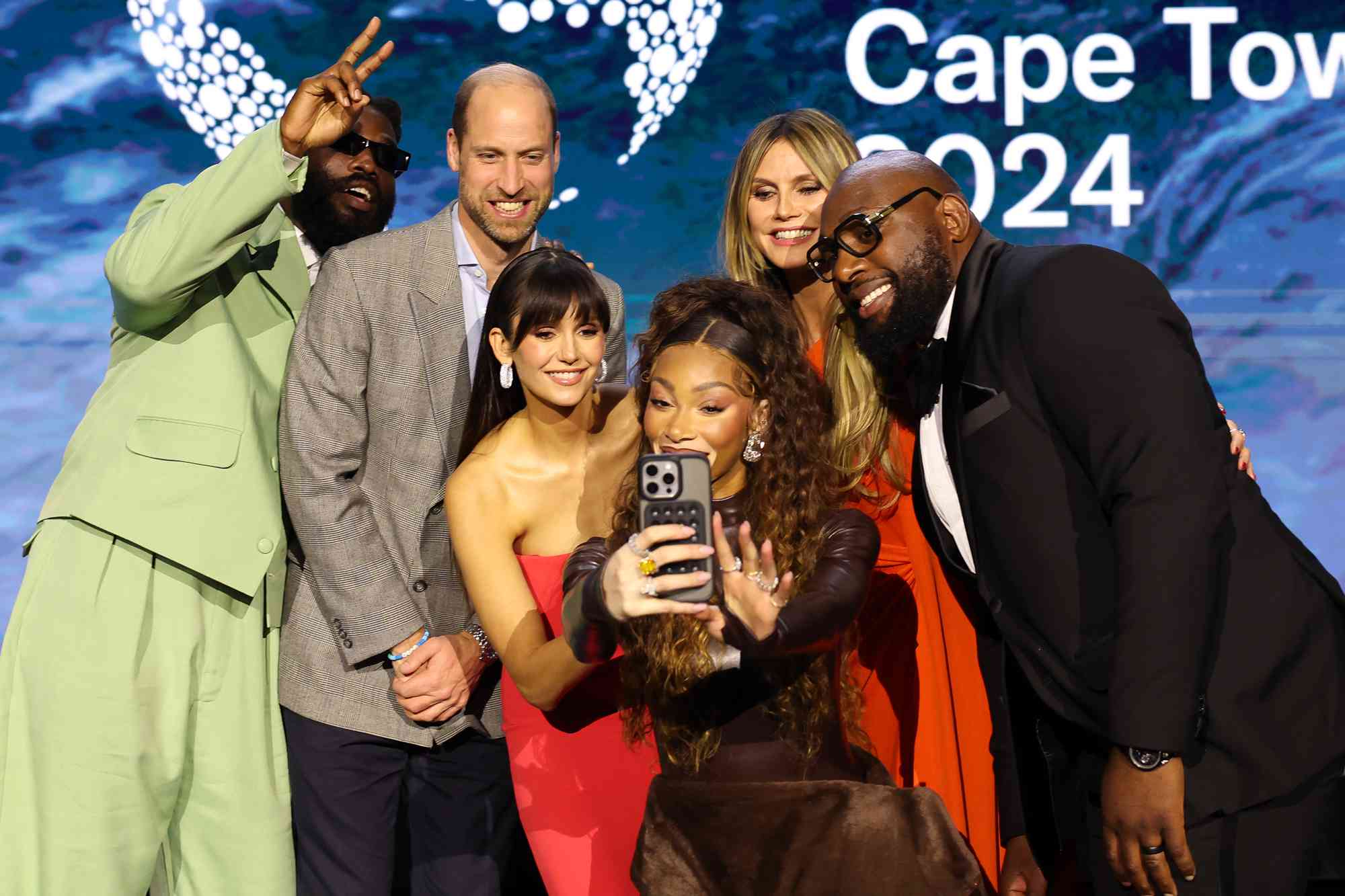 Britain's Prince William, Prince of Wales poses for a selfie with performers and presenters during the 2024 Earthshot Prize awards ceremony on November 6, 2024 in Cape Town, South Africa. During his visit, The Prince of Wales attended the fourth annual Earthshot Prize Awards and engaged in various environmental initiatives and participated in events held in Cape Town as part of 'Earthshot Week'. 