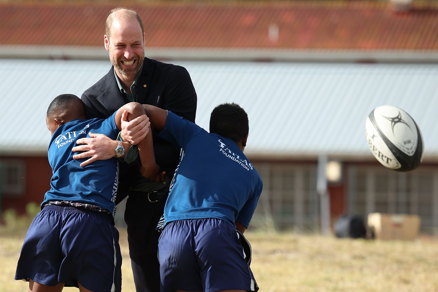 Prince William, Prince of Wales takes part in a rugby coaching session with local school children during a visit to Ocean View Secondary School on November 4, 2024 in Cape Town