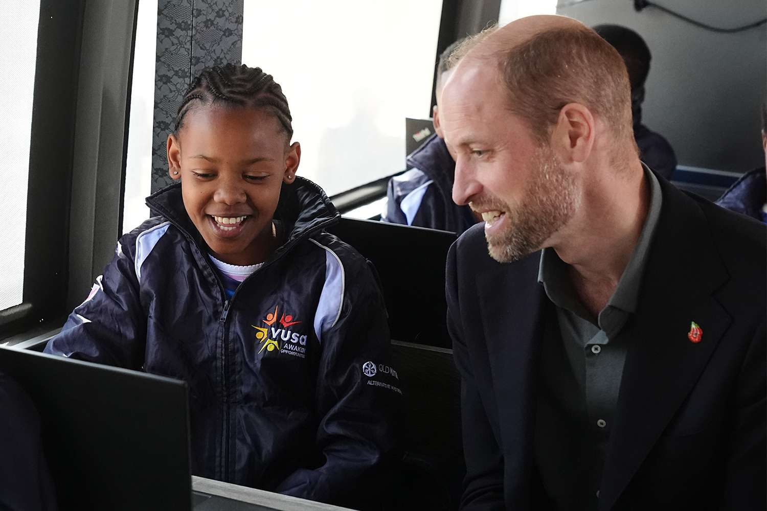 Prince William, Prince of Wales meets primary school children from Langa Township taking part in a digital skills lessons on the Atlas DigiBus, during a visit to Ocean View Secondary School on November 4, 2024 in Cape Town, South Africa