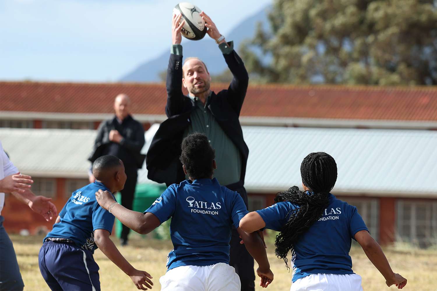 Prince William, Prince of Wales takes part in a rugby coaching session with local school children during a visit to Ocean View Secondary School on November 4, 2024 in Cape Town