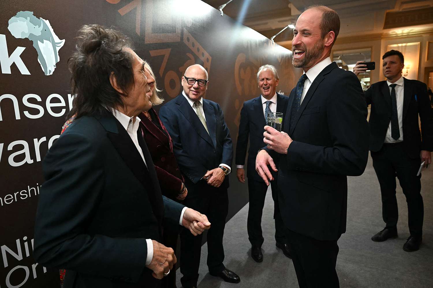 Britain's Prince William, Prince of Wales (2R) meets Musicians Ronnie Wood (L) and Mark Knopfler (2L) ahead of the ceremony for 12th annual Tusk Conservation Awards, at The Savoy Hotel in London on November 27, 2024. 