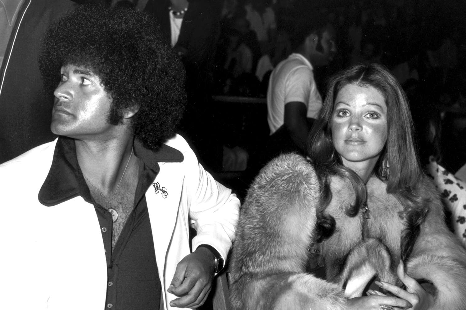 Priscilla Presley sits with her boyfriend, karate instructor Mike Stone, at a kung fu tournament in April 1975 at the Beverly Hills High School, CA.