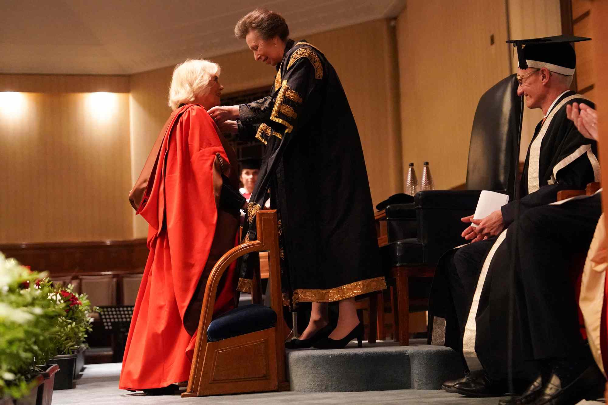 Britain's Queen Camilla (L) receives an Honorary Doctorate of Literature by Britain's Princess Anne, Princess Royal during a ceremony at the University of London, in London, on November 20, 2024. 