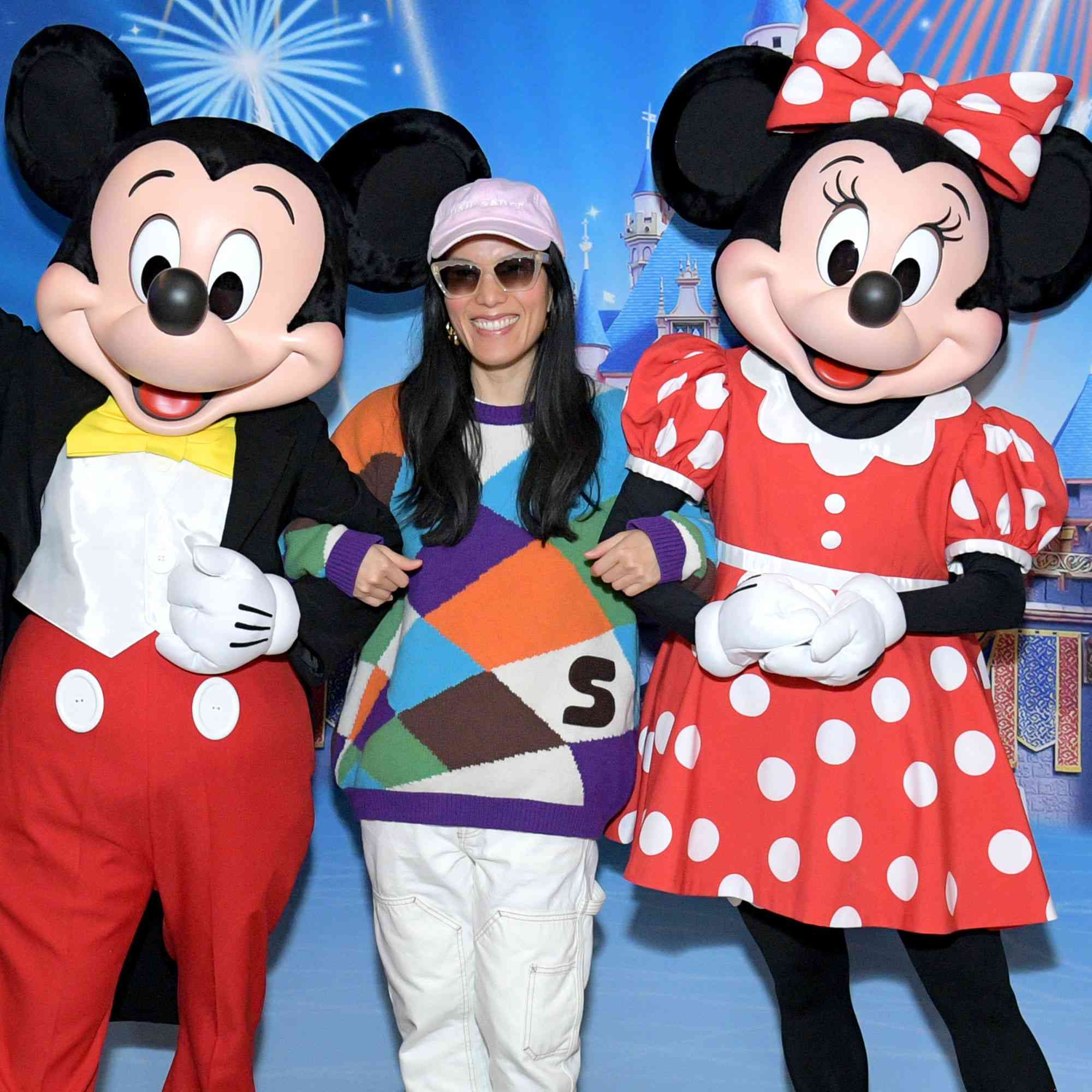 Ali Wong is greeted by Mickey Mouse and Minnie Mouse before enjoying Disney On Ice Presents Magic In The Stars at Crypto.com Arena on December 21, 2024