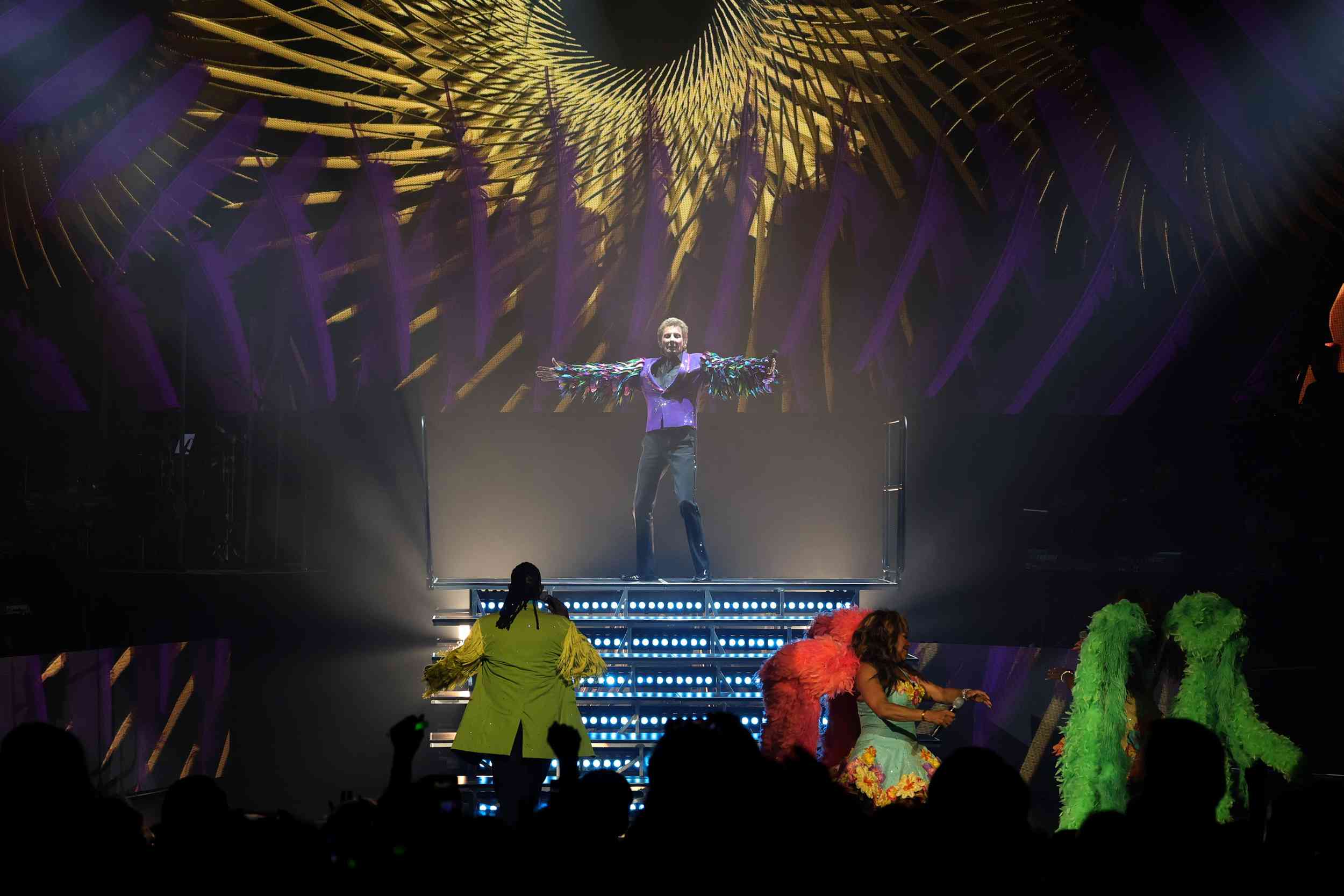 Barry Manilow (C) performs during the first of his three "Record-Breaking Charity Weekend Celebration" shows as part of his residency "Barry Manilow - The Hits Come Home!" at the International Theater at the Westgate Las Vegas Resort