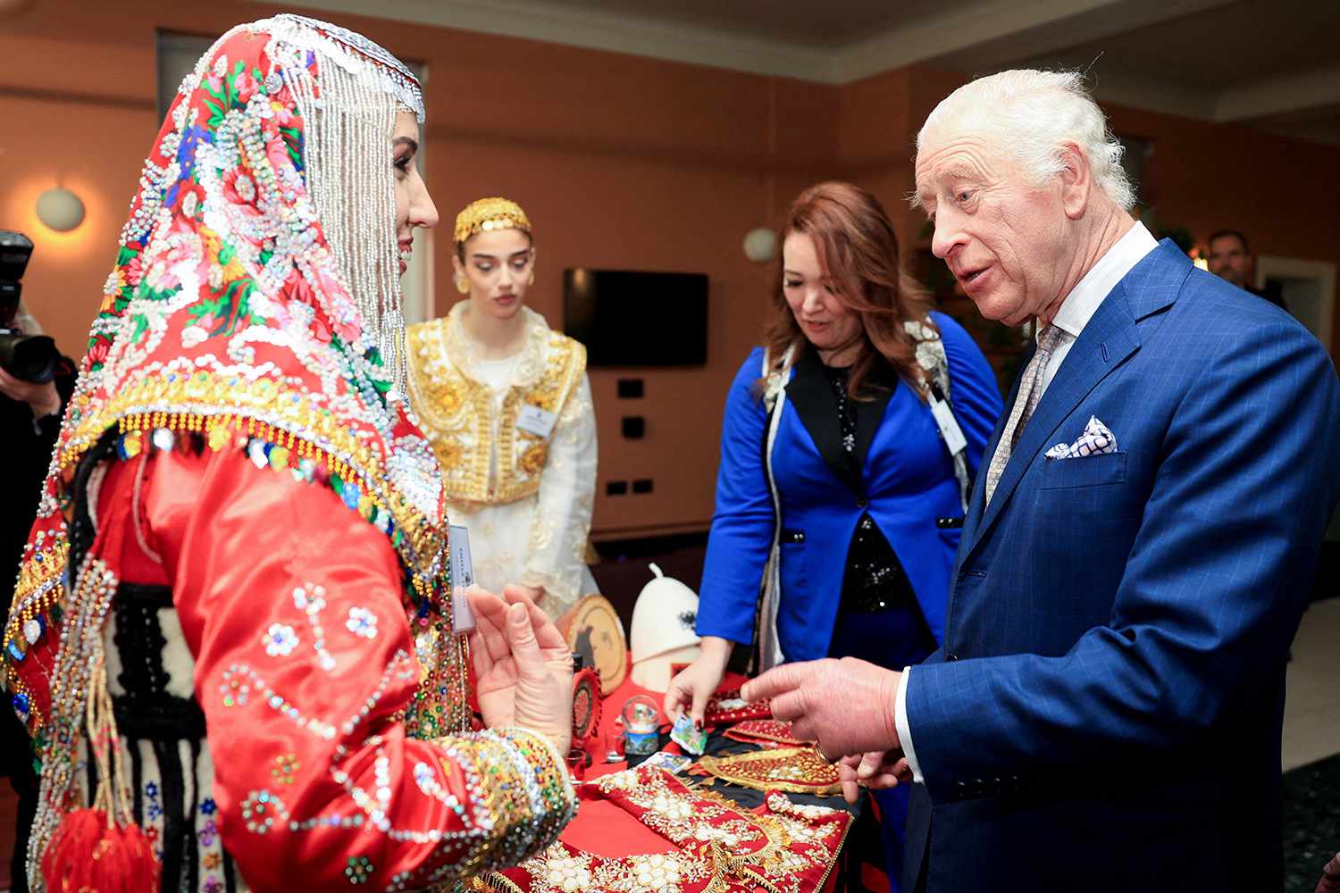 Britain's King Charles III speaks with a guest during a reception at Waltham Forest Town Hall in London on December 20, 2024, to meet local community volunteers, young people, emergency services, and faith representatives operating in Waltham Forest.