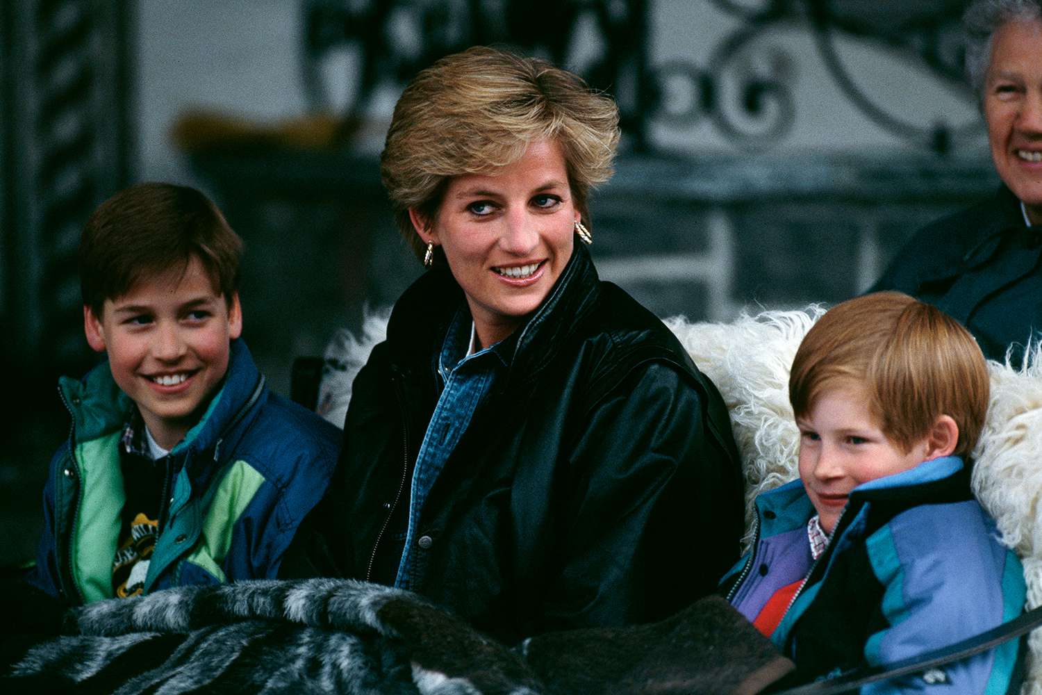 Diana, Princess of Wales (1961 - 1997) riding in a traditional sleigh with Prince William and Prince Harry during a skiing holiday in Lech, Austria, 30th March 1993. 