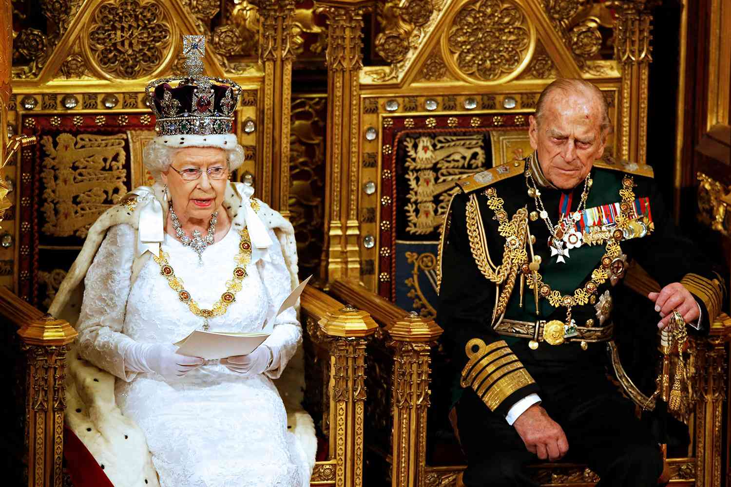 Britain's Queen Elizabeth II sits beside her husband Prince Philip, Duke of Edinburgh, as she delivers the Queen's Speech during the State Opening of Parliament in London on May 18, 2016.