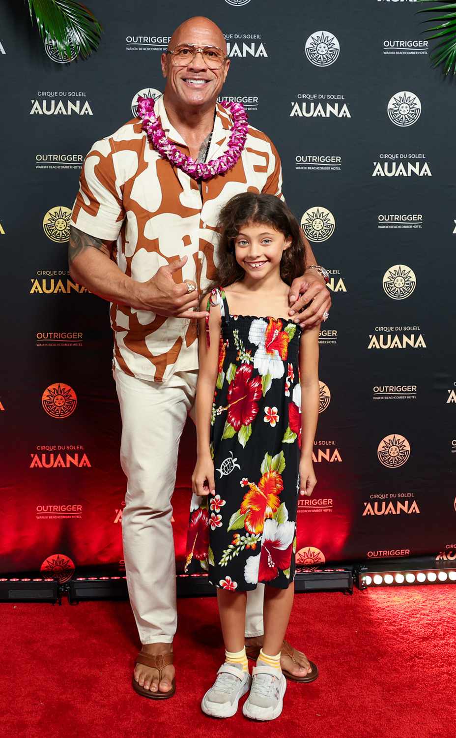 Dwayne "The Rock" Johnson, left, and his daughter Jasmine Johnson, joins cast and cultural visionaries, applauding the global premiere of Cirque du Soleil 'Auana at the OUTRIGGER Waikiki Beachcomber Hotel, a show blending Hawaiian legends with Cirque's iconic acrobatics