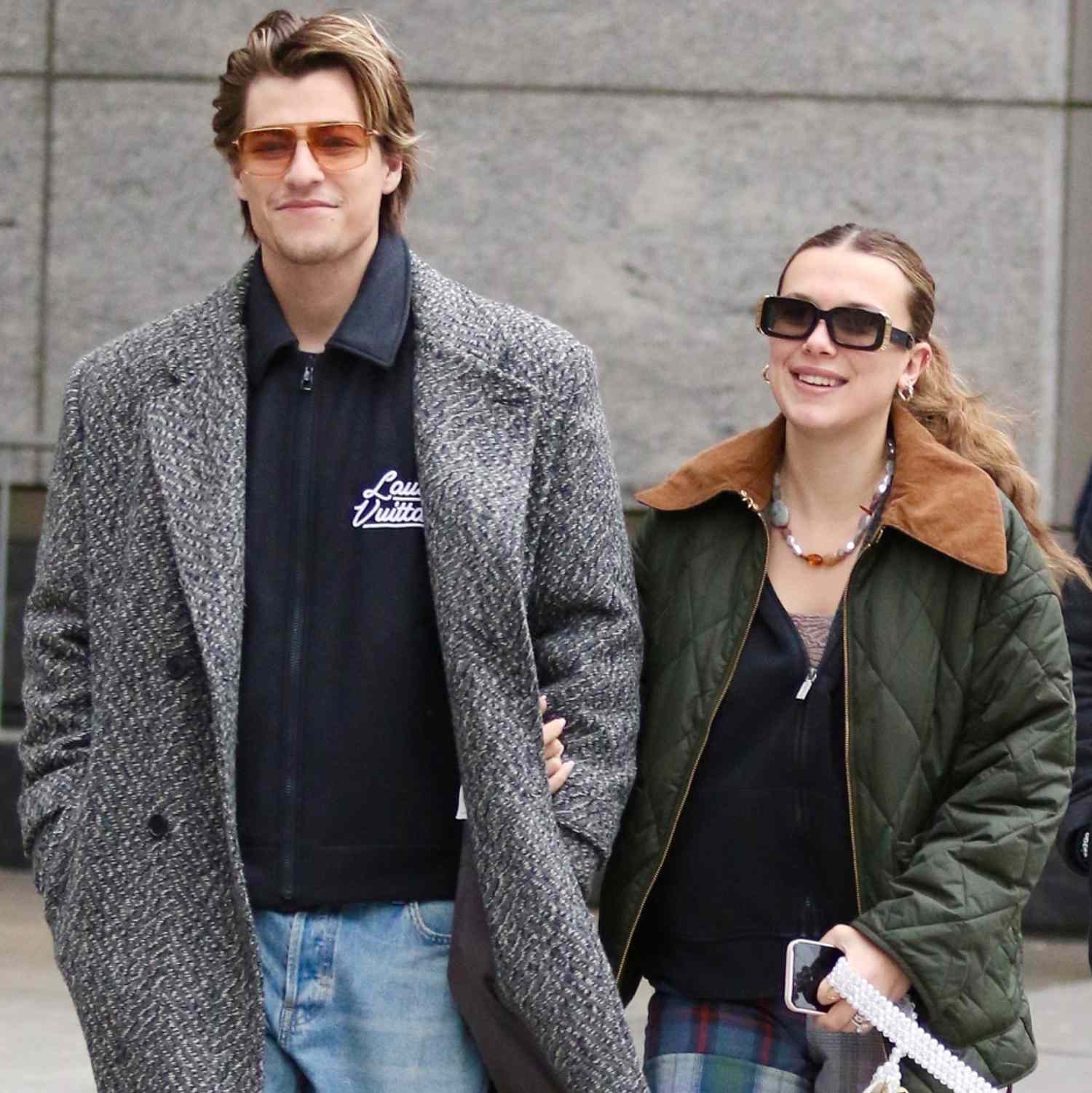 Millie Bobby Brown and her husband Jake Bongiovi share smiles and hold hands during a romantic walk in 