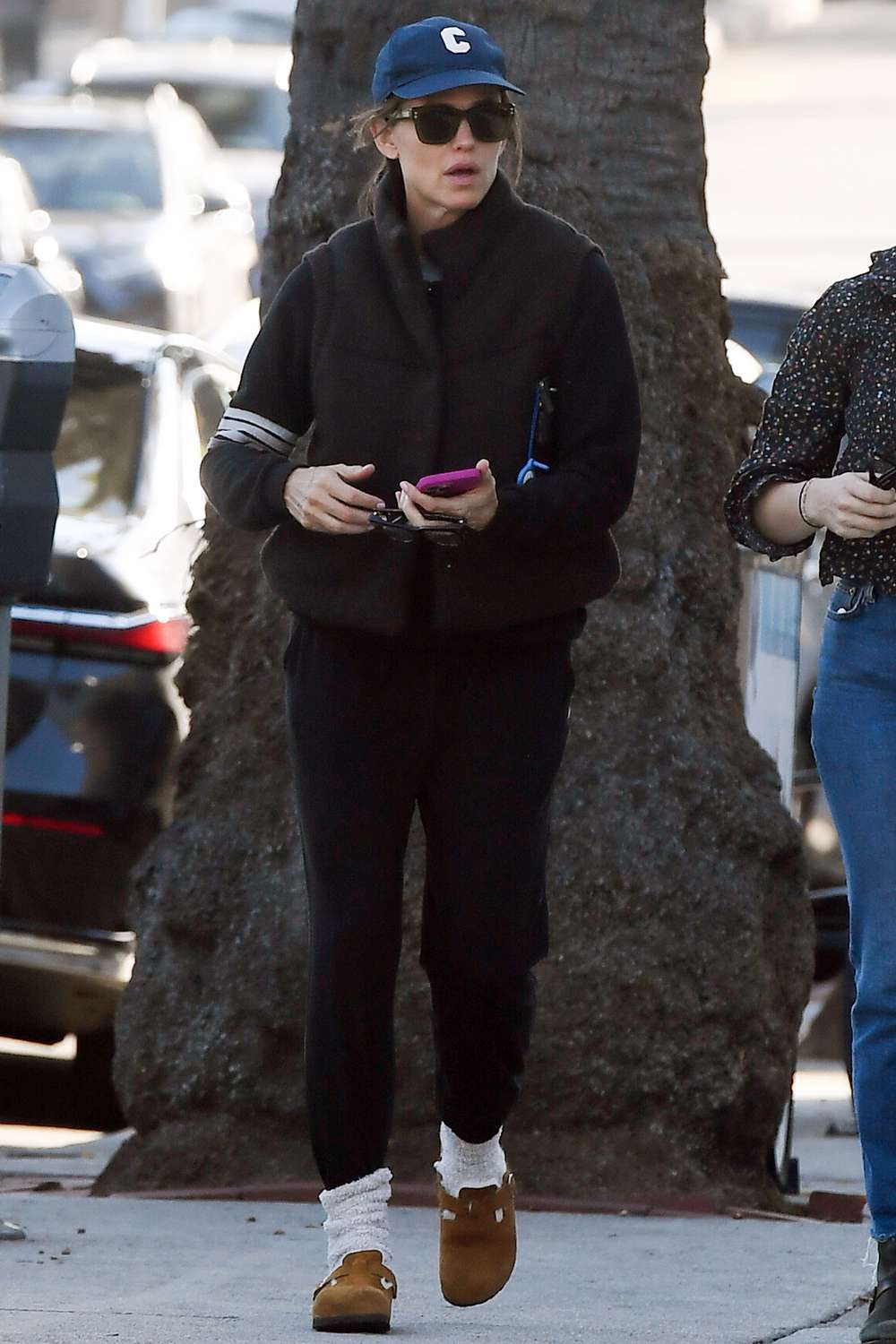 Jennifer Garner heads out for coffee with a friend in Los Angeles. The sighting comes after reuniting with ex Ben Affleck for Thanksgiving. Garner wore a baseball cap, puffer jacket, black joggers, and Birkenstock Boston clogs.