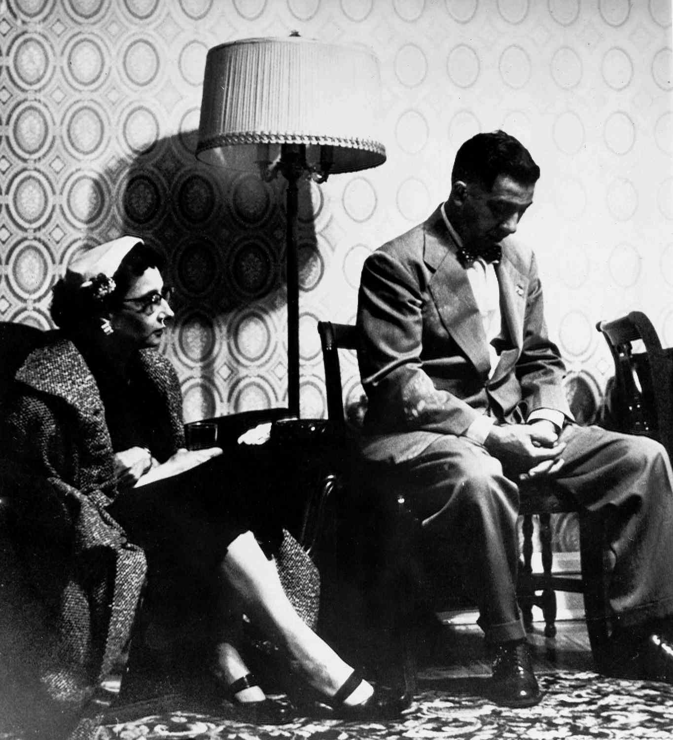 Mr. and Mrs. Michael Ridulph await the arrival of a pathologist at the sheriff's office in Galena, Ill., before a positive identification of a body found near Woodbine, Ill., can be made, April 27, 1958.