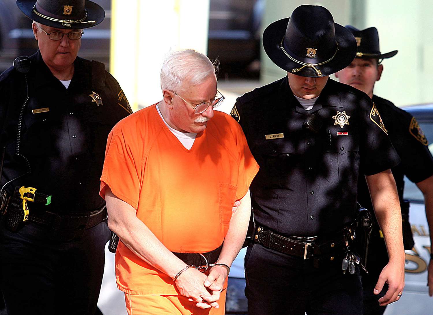 Jack McCullough is escorted into the DeKalb County Courthouse in Sycamore, Ill., by DeKalb County Sheriff's deputies. On Friday, Sept. 14, 2012, 