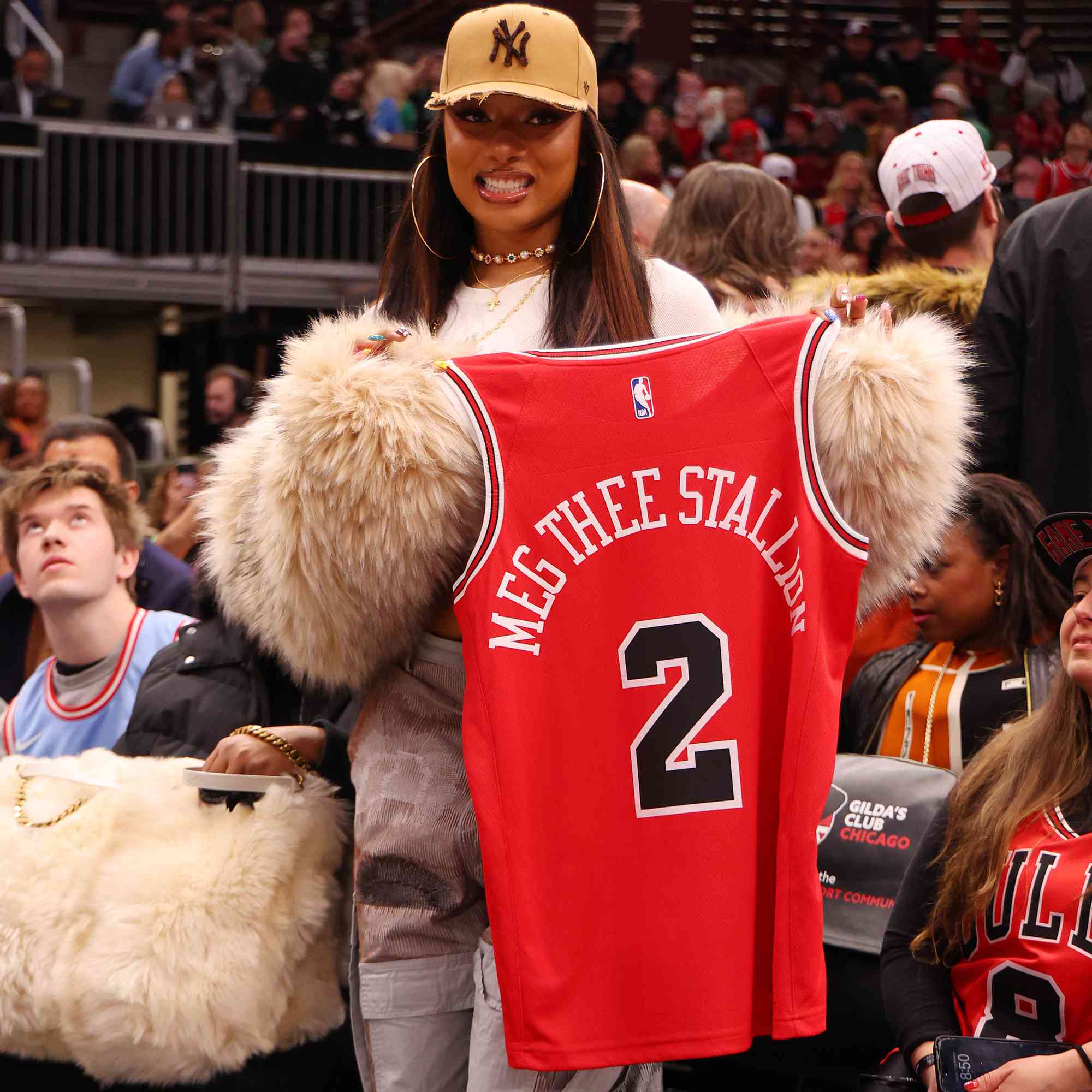 Rapper Megan Thee Stallion looks on during the second half between the Chicago Bulls and the Boston Celtics at the United Center on December 21, 2024 in Chicago, Illinois.