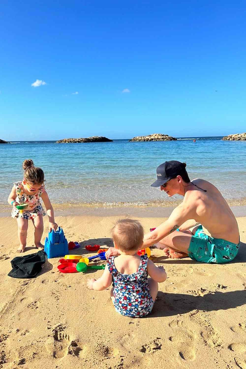 Molly Yeh's husband Nick Hagen on the beach with their two daughters.