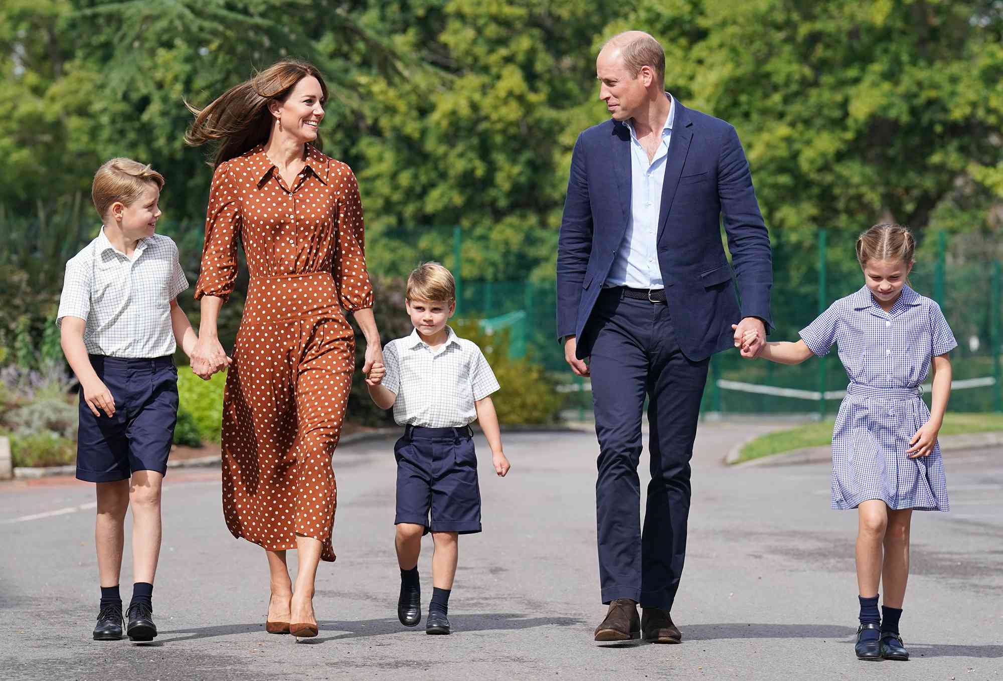 Prince George, Princess Charlotte and Prince Louis (C), accompanied by their parents the Prince William, Duke of Cambridge and Catherine, Duchess of Cambridge, arrive for a settling in afternoon at Lambrook School