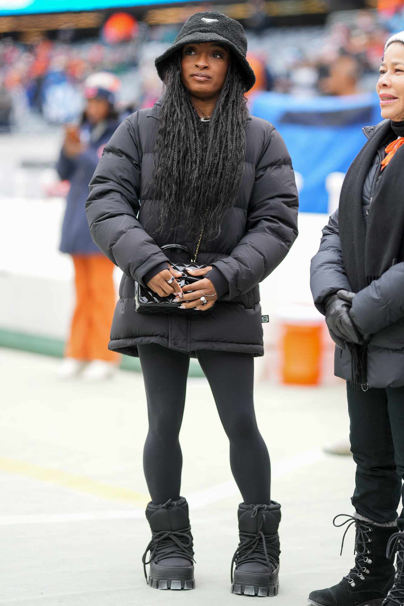 Olympic gold medalist Simone Biles stands on the slidelines prior to an NFL football game between the Detroit Lions and Chicago Bears at Soldier Field on December 22, 2024 in Chicago, Illinois. 