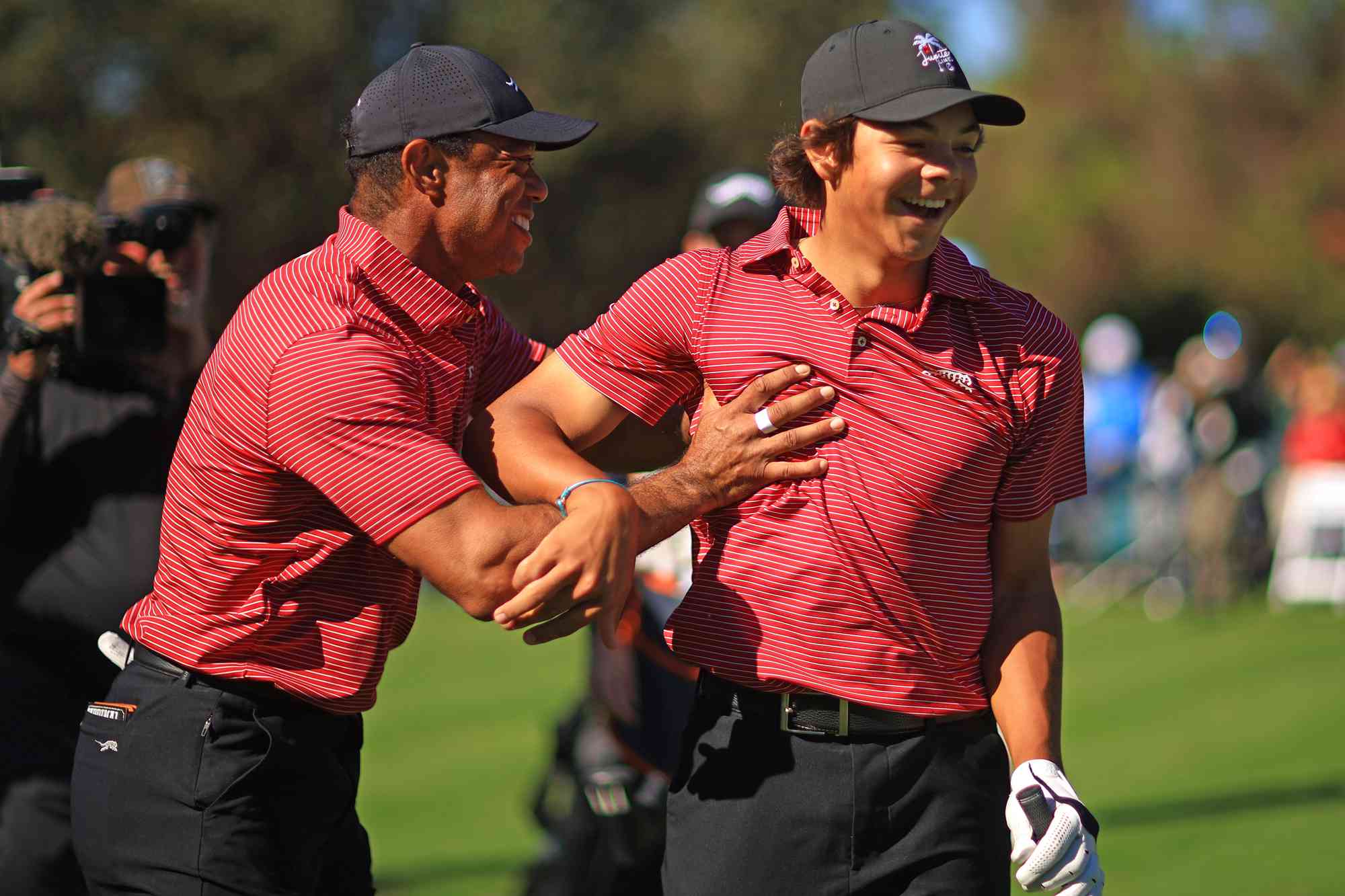 Tiger Woods of the United States reacts with his son Charlie Woods after holing out on the fourth hole during the second round of the PNC Championship at Ritz-Carlton Golf Club on December 22, 2024 in Orlando, Florida