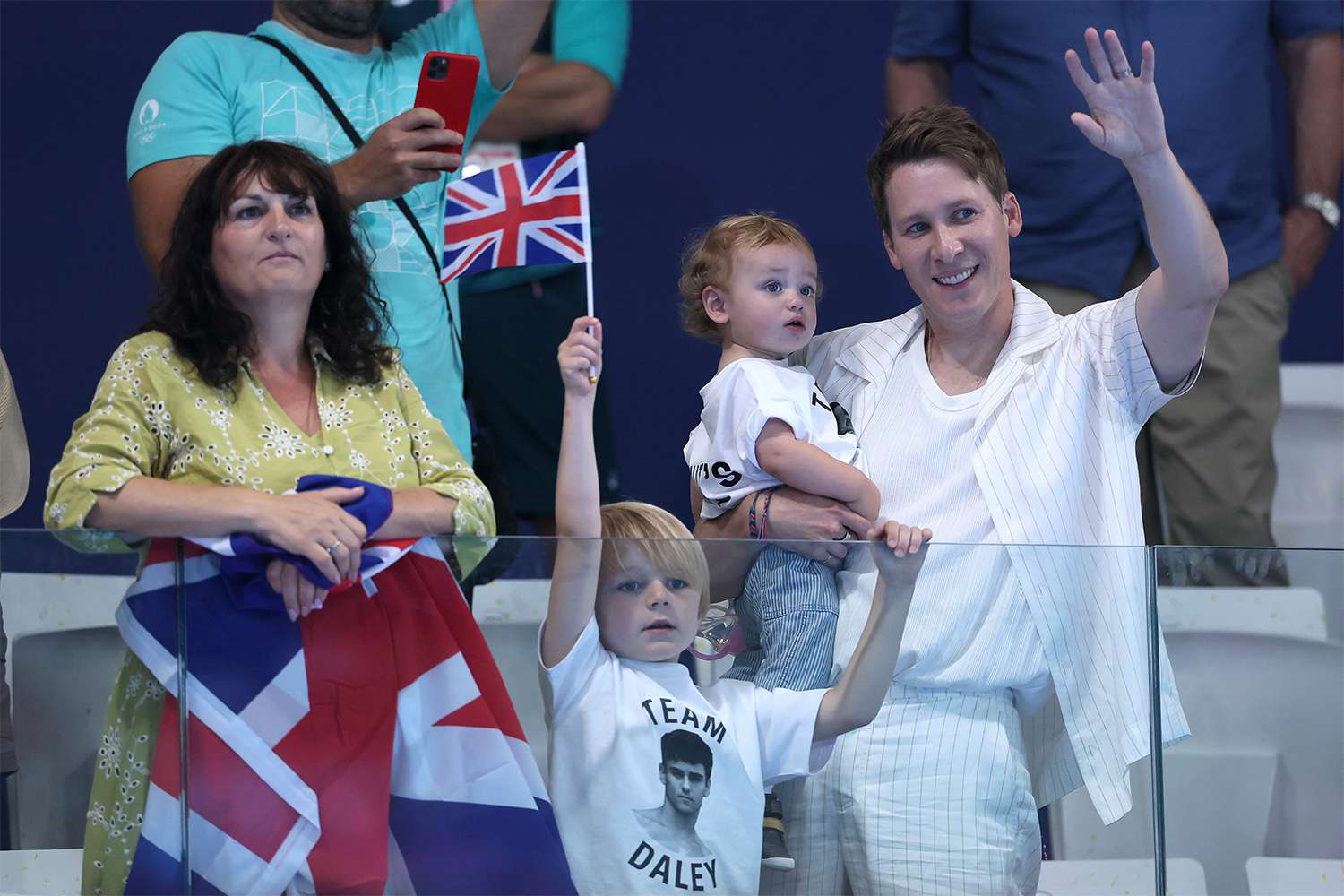 Debbie Daley, mother of Thomas Daley, Dustin Lance Black, husband of Thomas Daley, and their children are seen in attendance as they show their support