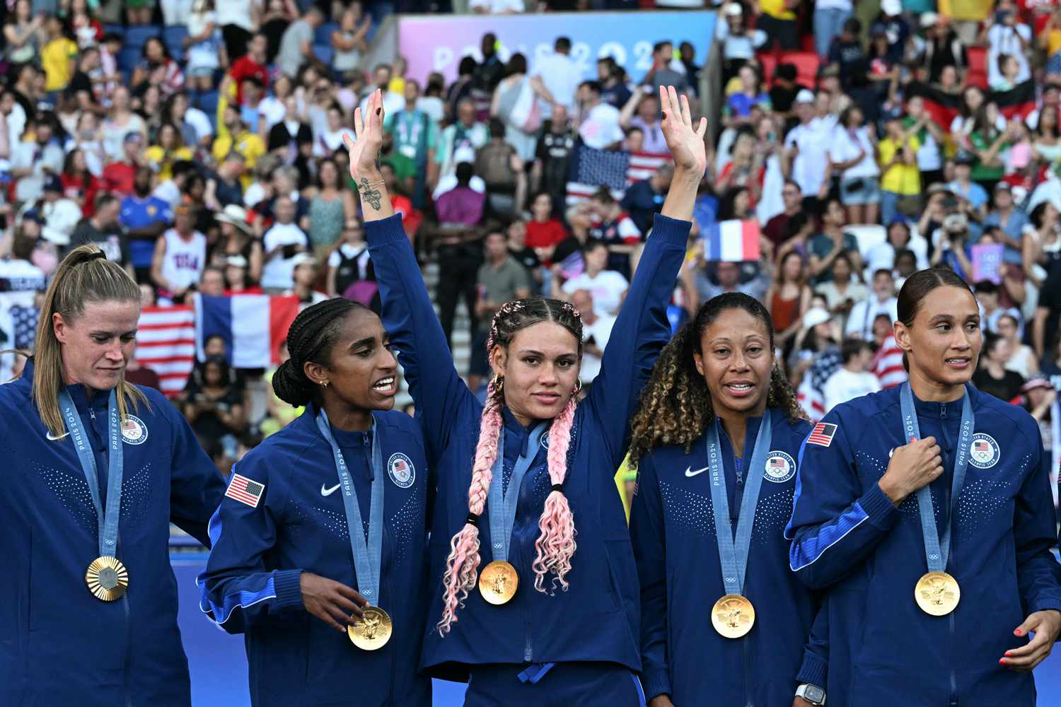 Gold medallist US' forward #05 Trinity Rodman (C) celebrates on the podium with teammates after the women's gold medal final football match between Brazil and US during the Paris 2024 Olympic Games at the Parc des Princes in Paris on August 10, 2024.