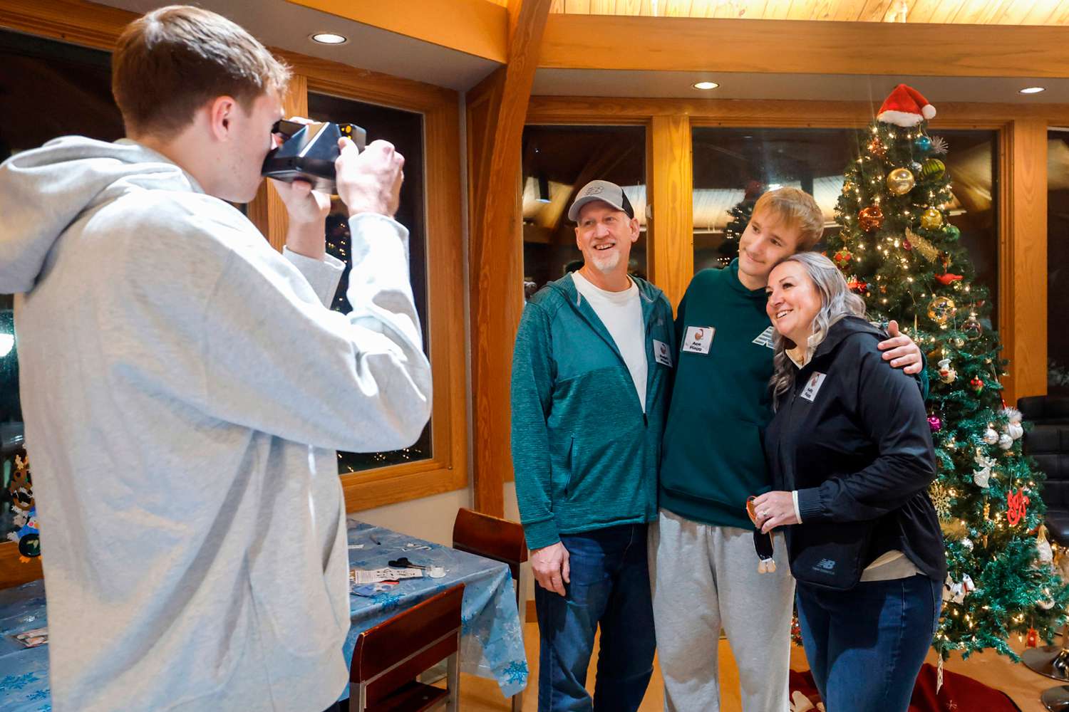 Cooper Flagg takes a Polaroid photo of his dad Ralph, brother Ace and mom Kelly after a holiday gathering on December 12, 2024 in Durham, North Carolina.