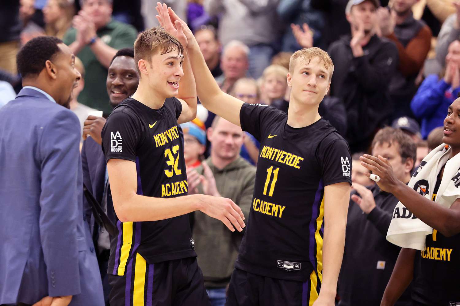 Twins Cooper (L) and Ace Flagg high-five during the game against CATS Academy Boston at Portland Expo.