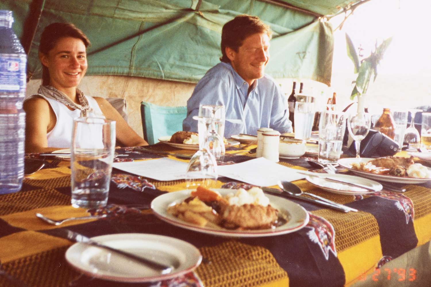 Melinda French (Melinda Gates) and John Neilson sitting at meal in tent, Tanzania, August 27, 1993