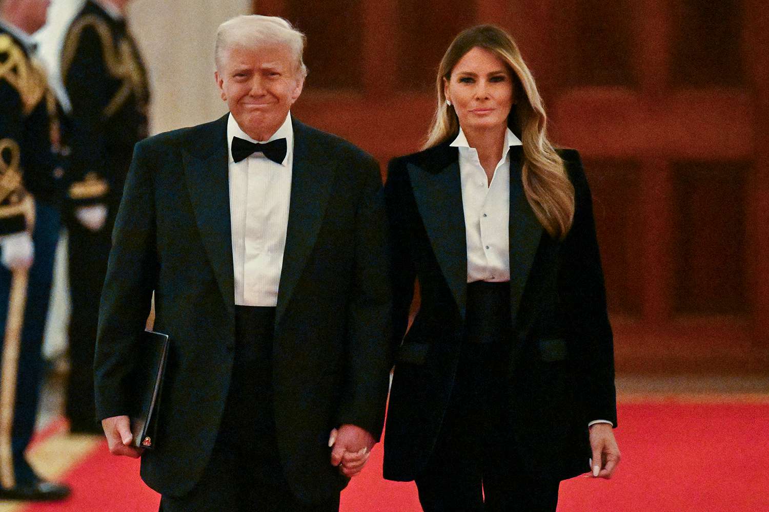 US President Donald Trump and US First Lady Melania Trump arrive for the National Governors Association Evening Dinner and Reception in the East Room of the White House in Washington, DC, on February 22, 2025.